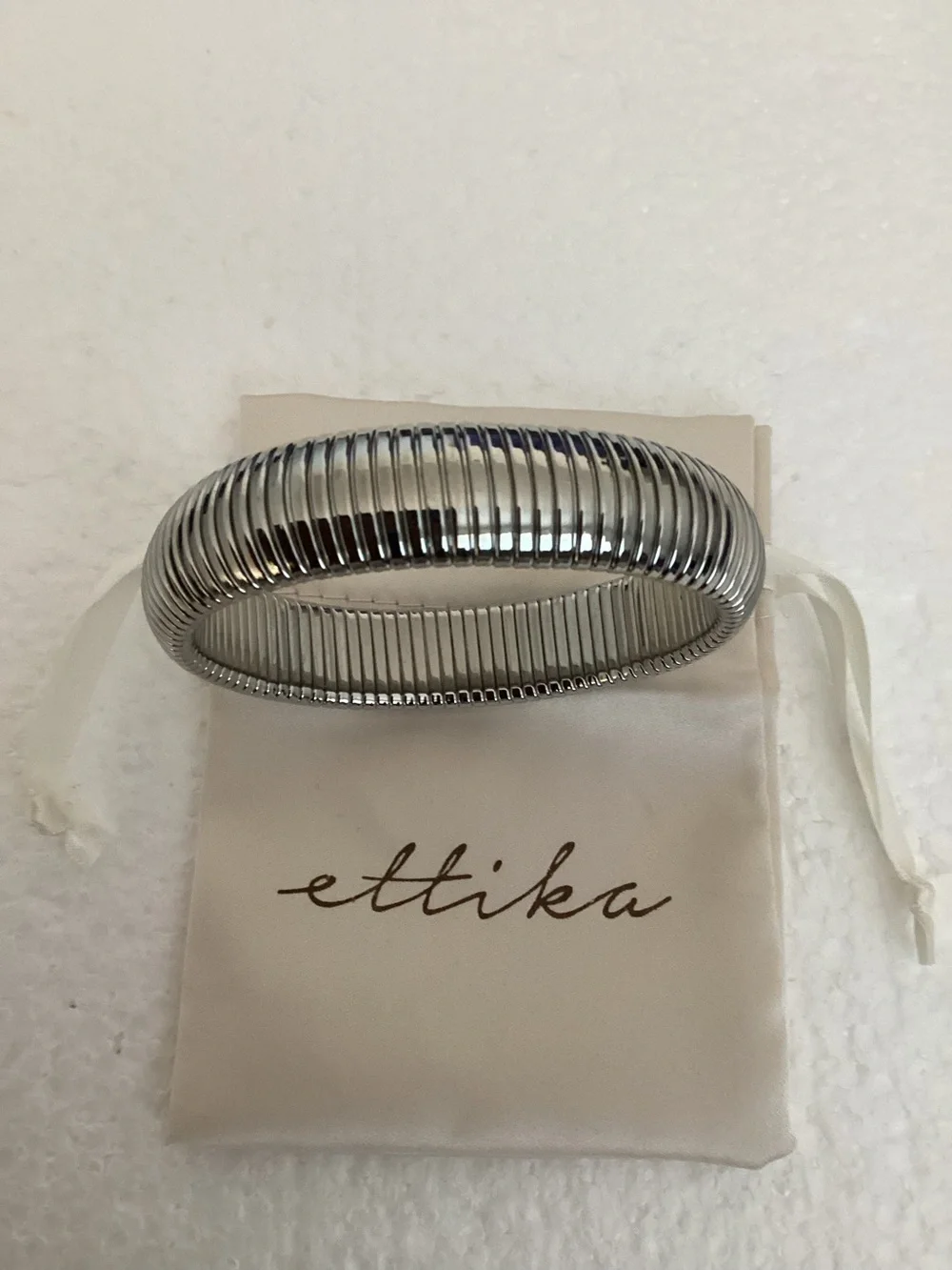 This Ettika silver-plated flexible tubogas-style stretch cuff silver tone brace